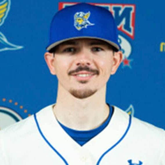 Conner smiling in his baseball uniform